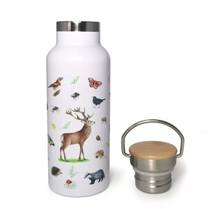 May include: White stainless steel water bottle with a woodland animal print design. The bottle has a bamboo lid with a stainless steel ring and a carrying handle.