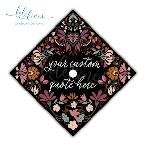 May include: Black graduation cap with a floral design in shades of pink, orange, and green. The cap features the text "your custom quote here" in white script. The top left corner has the text "lelelines GRADUATION CAPS".