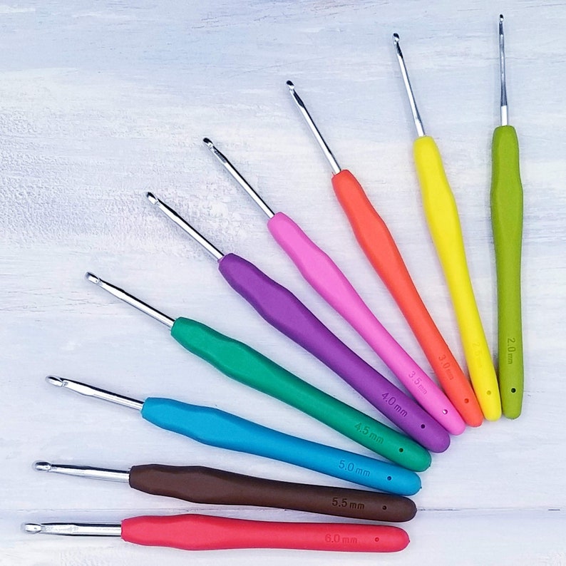 May include: A set of 10 crochet hooks in various colors, including red, orange, yellow, green, blue, purple, and brown. The hooks are labeled with their size in millimeters: 2.0 mm, 2.5 mm, 3.0 mm, 3.5 mm, 4.0 mm, 4.5 mm, 5.0 mm, 5.5 mm, and 6.0 mm.
