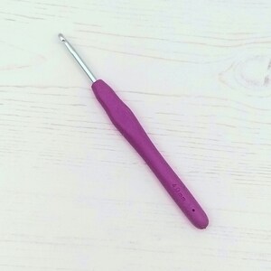May include: A purple 4.0 mm crochet hook with a silver hook.