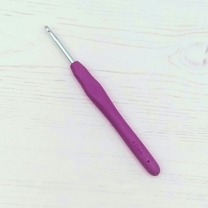 May include: A purple 4.0 mm crochet hook with a silver hook.