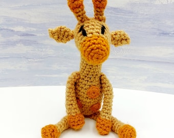 May include: A crocheted giraffe toy with brown and orange yarn. The giraffe has black eyes and a brown nose.