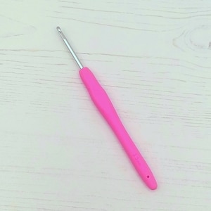May include: A pink crochet hook with a silver hook and a 3.5mm size marking.