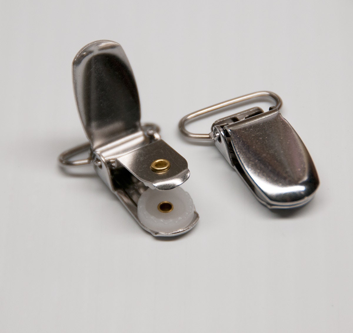 12 or 24 suspender clips, stainless steel suspender clips, silver ID card clips, belt clips, garters clips.