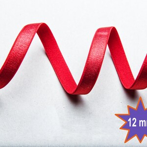 May include: Red satin ribbon with a slight sheen, curled into a wavy shape. The ribbon is 12 mm wide.