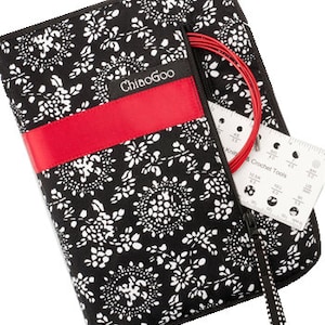 May include: A black and white floral patterned knitting needle case with a red accent band. The case is open, revealing red knitting needles, a gauge tool, and the "ChiaoGoo" brand name. The case is zippered and has a black and white patterned zipper pull.