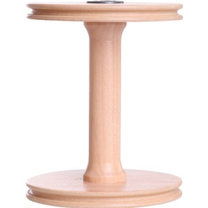 May include: A wooden yarn swift, featuring a round base and top with a central, cylindrical support. The natural wood color and simple design suggest a craft or textile theme. The swift is designed to hold yarn.