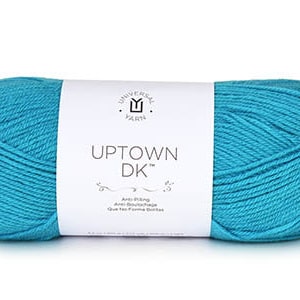 May include: A skein of turquoise blue yarn labeled "Uptown DK" by Universal Yarn. The label also states "Anti-Pilling, Anti-Splitting, Gives a Fine Smooth Stitch."