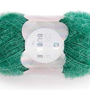 May include: A ball of green yarn with a fluffy texture. The yarn is wrapped with a white label that reads "CREATIVE BUBBLE". The yarn is a vibrant shade of green, perfect for knitting or crocheting projects.