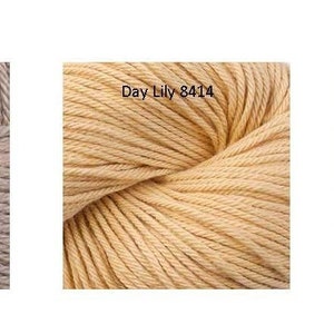 May include: Three skeins of yarn in different colors: a light brown skein labeled "Barley 8409", a light yellow skein labeled "Day Lily 8414", and a light green skein labeled "Chive 8415".