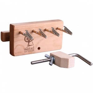 May include: Wooden yarn swift with four metal clips and a clamp for attaching to a table or surface. The swift is made by Ashford, New Zealand.