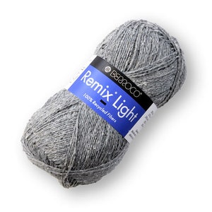 May include: A skein of gray yarn labeled "Remix Light" by Berroco. The yarn is 100% recycled fibers.