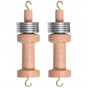 May include: Two wooden yarn swift with metal bobbins and hooks. The swifts are made of light brown wood and have a hook at the bottom. The bobbins are silver and are stacked on top of the swifts.