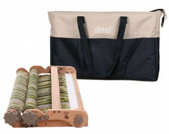 May include: A wooden loom with a green and white warp, folded and ready to be used. It comes with a black and beige tote bag with the text "Ashford Handweaving" printed on it.
