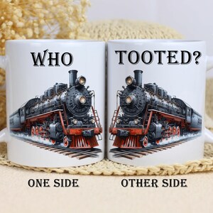May include: White ceramic mug with a black steam engine on one side and the text "WHO TOOted?" on the other side.