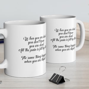 May include: Two white ceramic mugs with black text that reads "When you are dead you don't know you are dead. All the pain is felt by others. The same thing happens when you are asleep."