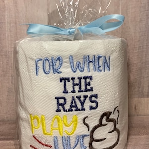 May include: A white toilet paper roll with blue and yellow embroidery that reads "For when the Rays play like" with a baseball and a brown poop emoji.