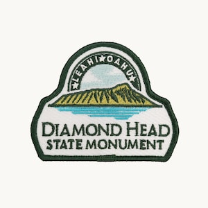 May include: An embroidered patch featuring a landscape of Diamond Head in Hawaii. The design includes a green mountain, blue water, and a sky with the text LEAHI OAHU. The bottom section displays the text DIAMOND HEAD STATE MONUMENT in dark green.