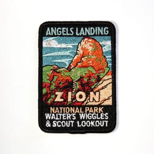 May include: Embroidered patch featuring a landscape scene of Angels Landing in Zion National Park. The patch has a black border and includes text that reads "Angels Landing," "Zion," and "National Park Walter's Wiggles & Scout Lookout." The image depicts a mountain with orange and green hues.