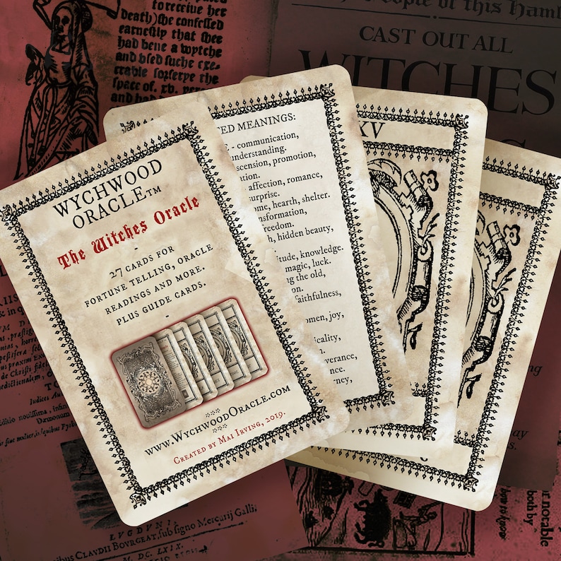 May include: A close-up of a set of tarot cards with a vintage aesthetic. The cards feature a black and white design with a decorative border. The cards are titled "The Witches Oracle" and feature the text "27 cards for fortune telling, oracle readings and more. Plus guide cards." The cards are laid out on a table with a red and white background.