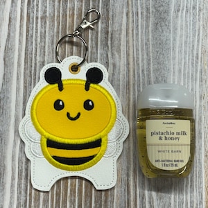 Soporte para desinfectante de manos con forma de abeja, organizador de desinfectante de manos, llavero para desinfectante, accesorio para bolso o cordón.
