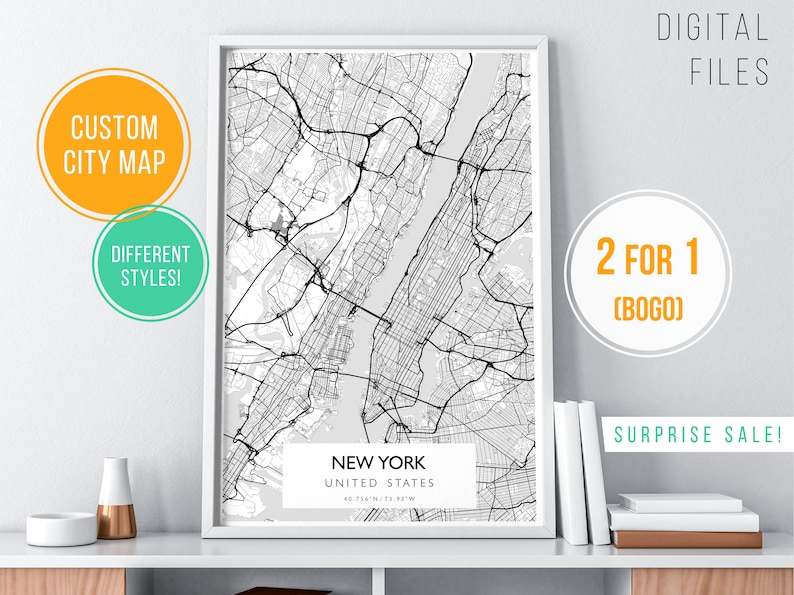 May include: A framed black and white map of New York City with the text "New York, United States, 40.7541&deg; N 73.9851&deg; W" printed below the map. The map is on a white shelf with a white vase and a copper vase on the shelf. The text "Digital Files, 2 for 1 (BOGO), Surprise Sale!" is printed on the wall behind the map.