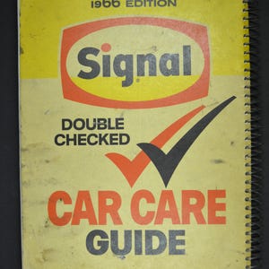 May include: A yellow and brown spiral bound book with the title "Signal Double Checked Car Care Guide" and the year "1966 Edition" printed on the cover.
