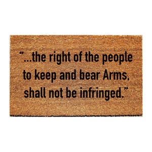 May include: A brown doormat with the text "...the right of the people to keep and bear Arms, shall not be infringed."