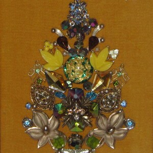 May include: A gold, green, and yellow jeweled Christmas tree ornament made of various vintage buttons and rhinestones.