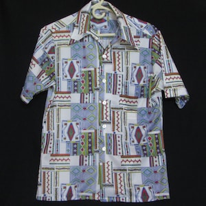 May include: A white short-sleeved button-down shirt with a geometric pattern in shades of blue, green, red, and yellow.