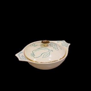 May include: A white ceramic serving bowl with a lid. The bowl and lid feature a green and gold design of fruit and grapes.
