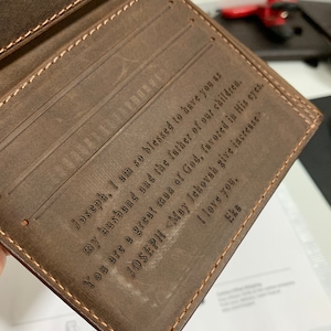 May include: A brown leather wallet with a personalized inscription that reads "Joseph, I am so blessed to have you as my husband and the father of our children. You are a great man of God, favored in His eyes. JOSEPH <May Jehovah give increase I love you, Eka"