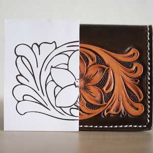 May include: A close-up of a brown leather wallet with a floral design. The design is embossed into the leather and is a light brown colour. A white paper with a black outline of the same design is next to the wallet.