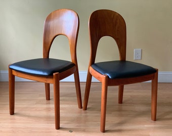 TWO MORTEN solid teak dining chairs in black leather