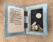 Mixed media penguin art in a hand painted wooden box, featuring vintage lead toy