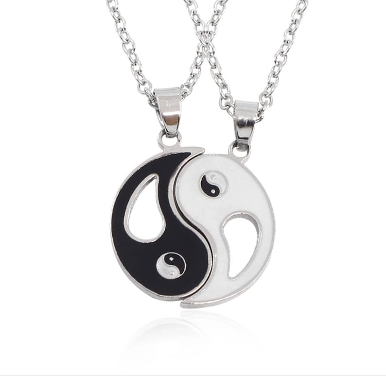 A Pair of Ying and Yang Necklaces on 18 Inch Chains.