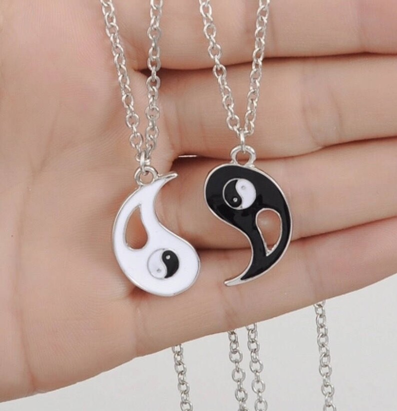 A Pair of Ying and Yang Necklaces on 18 Inch Chains.