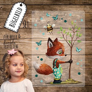 Könnte beinhalten: Ein Set Bügelbilder mit einem Fuchs, der einen Baum pflanzt, einer Biene und Schmetterlingen. Der Text "Für helle & dunkle Textilien" ist auf dem Bild zu sehen.
