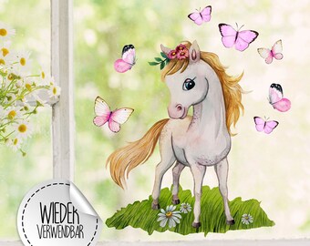 May include: A white unicorn with a pink flower crown and a flowing mane stands on a green field with pink butterflies. The text "WIEDER VERWENDBAR" is on a white circle sticker.
