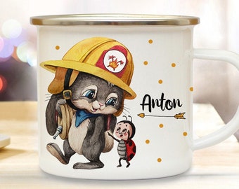 May include: White enamel mug with a cartoon illustration of a bunny wearing a firefighter helmet and holding a hose. The bunny is standing next to a ladybug. The mug has the name Anton written on it.