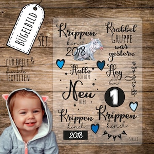 Può includere: Set di trasferimenti da stirare per tessuti chiari e scuri. Il set include un design con un ippopotamo bambino, il testo "Krippen Kind 2018" e altre frasi come "Hallo, ich bin neu hier" e "Hey, ich bin 1".
