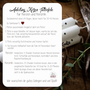 May include: A white card with instructions for applying candle tattoo foil to candles and ceramics. The card includes steps for cutting, applying, and drying the foil. Two white candles with black heart designs are in the background.
