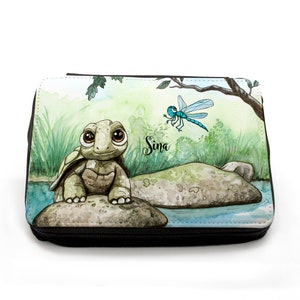 May include: A green and brown turtle with big eyes sits on a rock by a pond. A blue dragonfly flies above the turtle. The name "Sina" is written on the background.