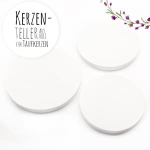 May include: Three white round wooden candle plates, with the text "KERZEN-TELLER AUS HOLZ F&Uuml;R TAUFKERZEN" on one of the plates.