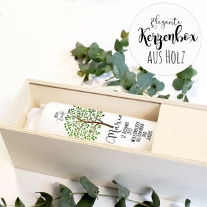 May include: A white wooden box with a white label that says "MEINE Taufe Marie 12. DEZEMBER 2019 WIR LIEBEN DICH BIS ZUM MOND UND ZUR&Uuml;CK". The box is decorated with a green tree illustration. The box is labeled "Elegante Kerzenbox AUS HOLZ".