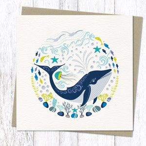 Colourful Blue whale greeting card in our circular Nordic folk art style. It features a whale in deep blue, followed by a shoal of little fishes , pebbles, coral and jelly fish in bright contemporary coastal colours.