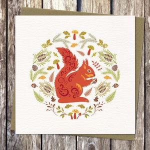 Square Card with Scandinavian style Squirrel illustration. Isle of Wight Red Squirrel surrounded by forest ferns, pinecones, toadstools and leaves, in bold, bright autumn colours capturing the spirit of Nordic Folk art.