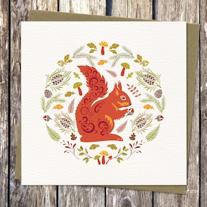 Square Card with Scandinavian style Squirrel illustration. Isle of Wight Red Squirrel surrounded by forest ferns, pinecones, toadstools and leaves, in bold, bright autumn colours capturing the spirit of Nordic Folk art.