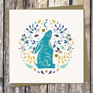 Moon Gazing Hare card - a mystical card with a magical hare amongst moon and stars, oak leaves and ferns, in a contemporary folk art style