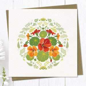 Circular folk art style illustration of orange nasturtium flowers surrounded by decorative botanical elements. My designs are inspired by nordic folk art and bright colours.
Square Greeting Card with brown eco envelope.